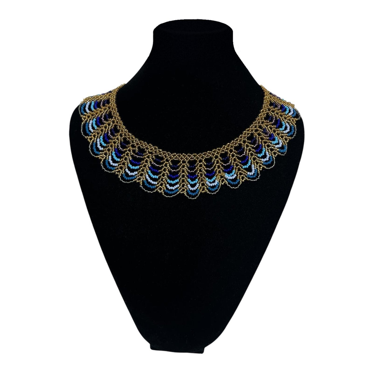 Peacock Blue & Gold Scalloped Beaded Collar Necklace on velvet stand, handmade Colombian glass bead necklace by Zenú women