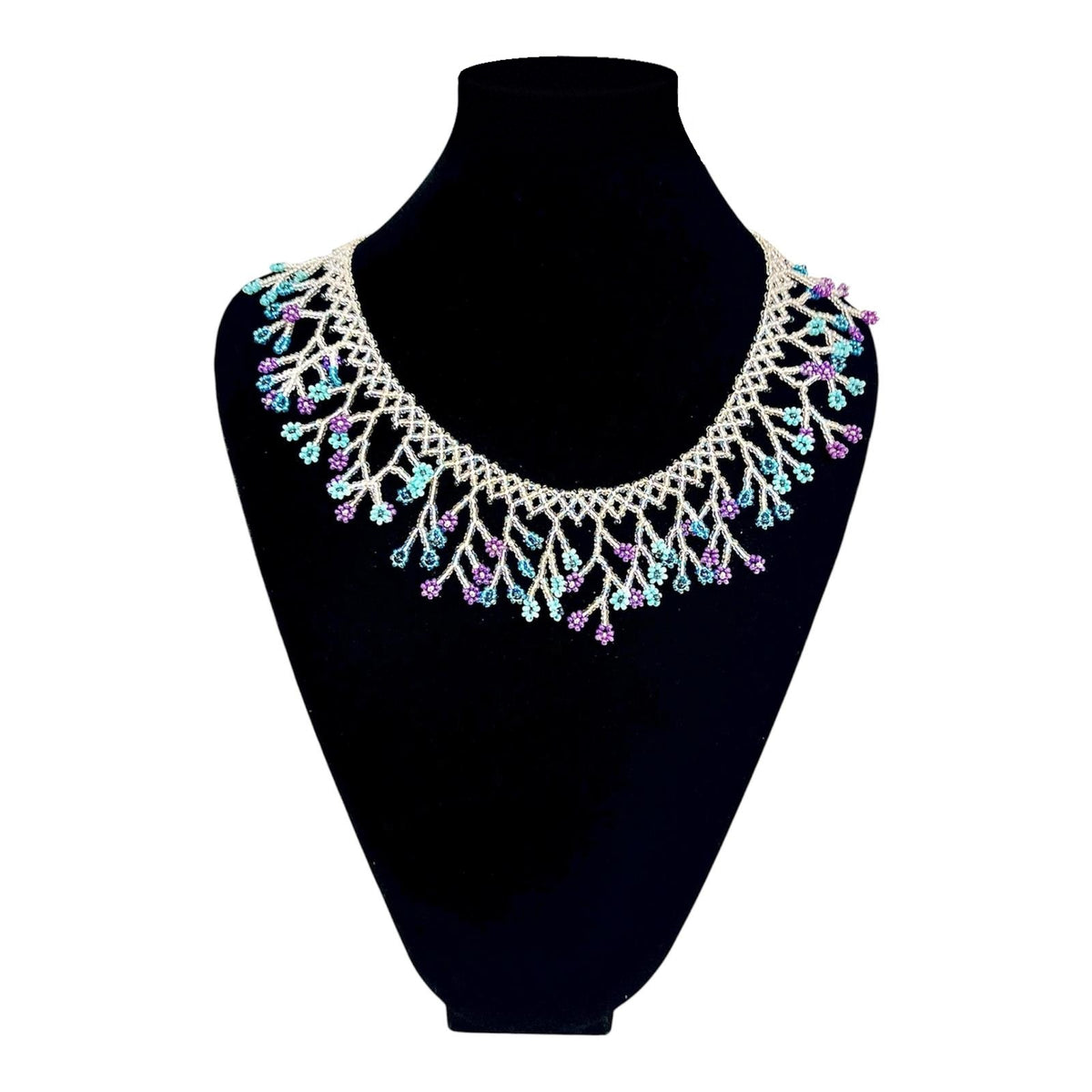 Silver & Teal Blossom Fringe Beaded Collar Necklace on velvet stand, handmade Colombian glass bead necklace by Zenú women