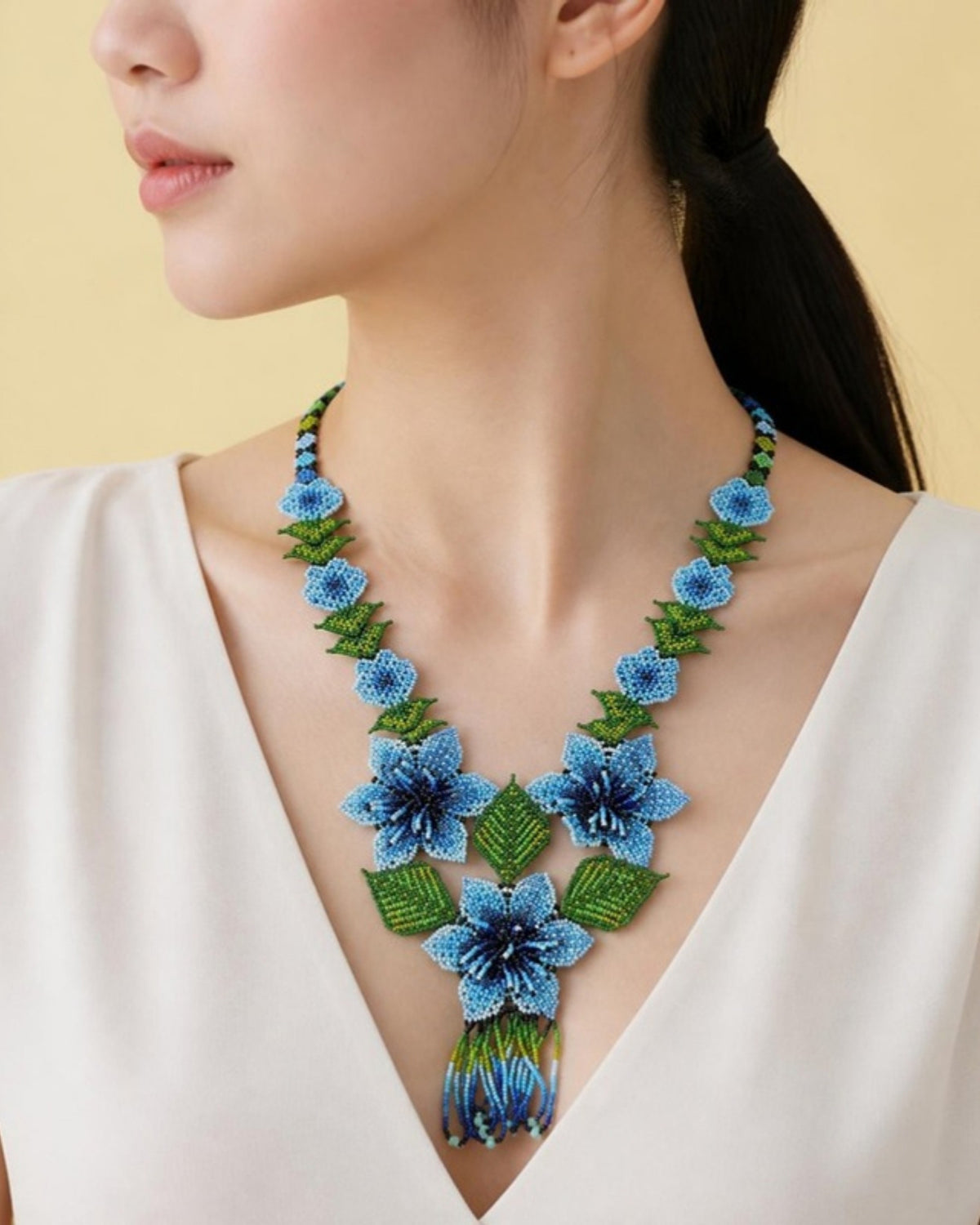 Model wearing Blue Flower Garland Beaded Drop Necklace, handmade Colombian glass bead necklace