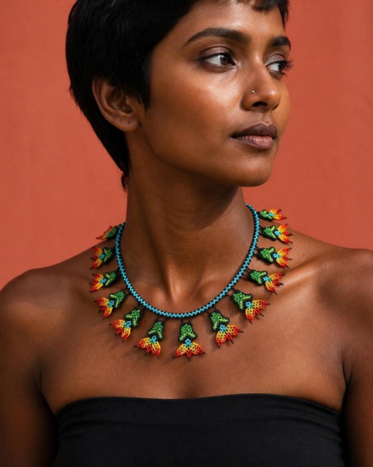 Model wearing Green Flame Flower Beaded Necklace, handmade Colombian glass bead necklace